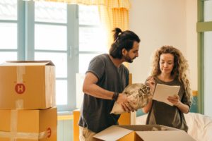 Man and woman packing moving boxes,